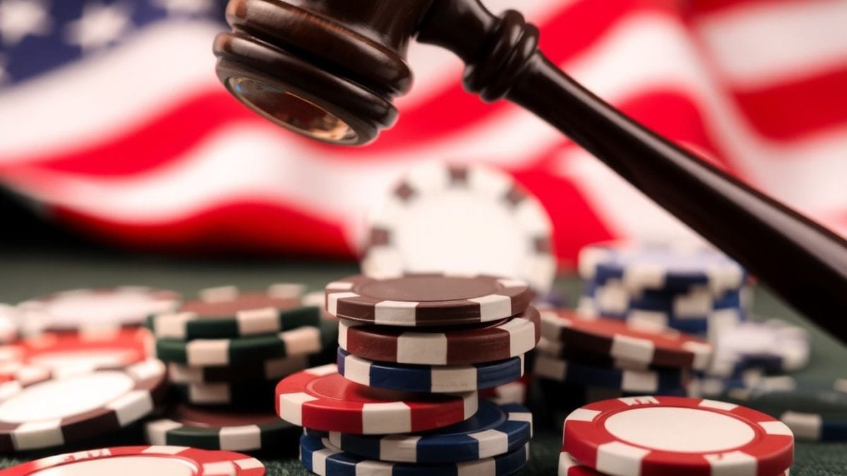 Gavel striking poker chips, American flag background.