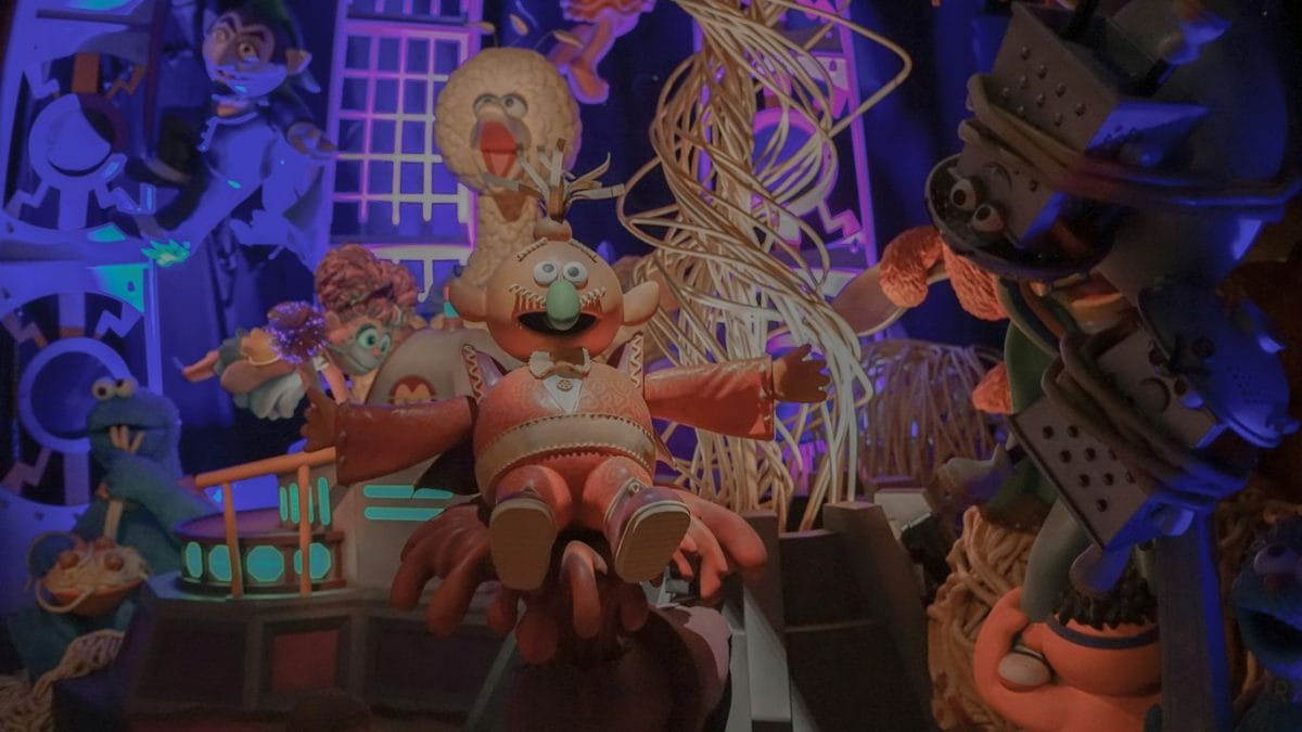 An animated scene of a man sitting on a bench